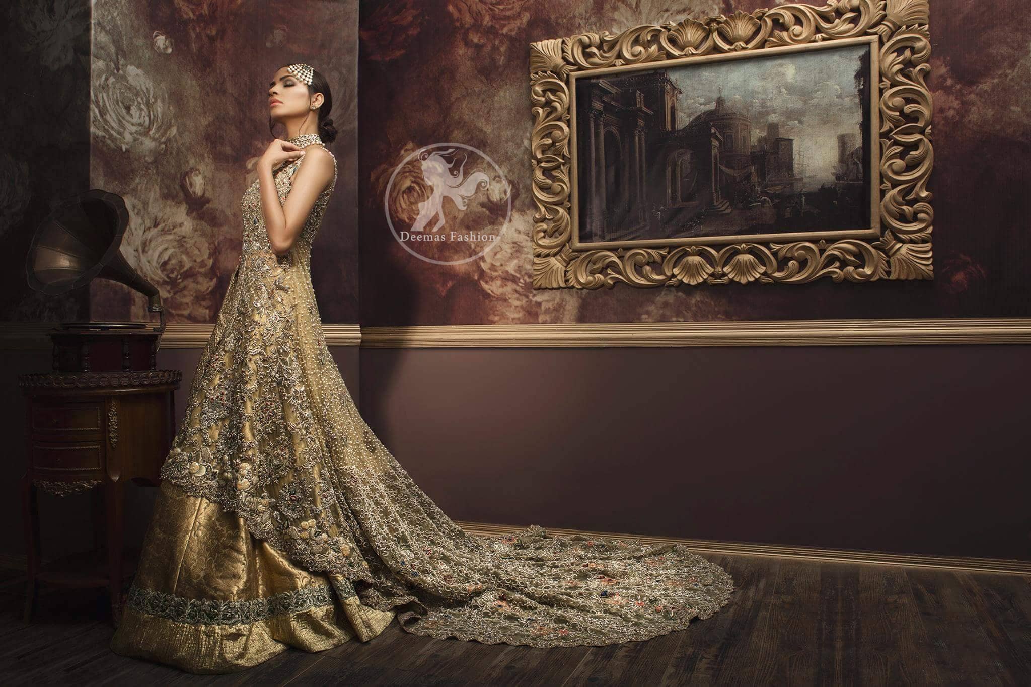 Golden organza lehengha comes with pure crinkle chiffon dupatta having heavy embroidery. Dress comes with front open long back trail gown.