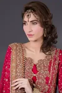 Crimson A-line slits shirt adorned with a beautiful neckline, stripes, and hemline. The matching dupatta has an embellished border on four sides, sequins, and small motifs sprayed all over it. Lehenga in Crimson and Copper has embellished Gott-like gharara.