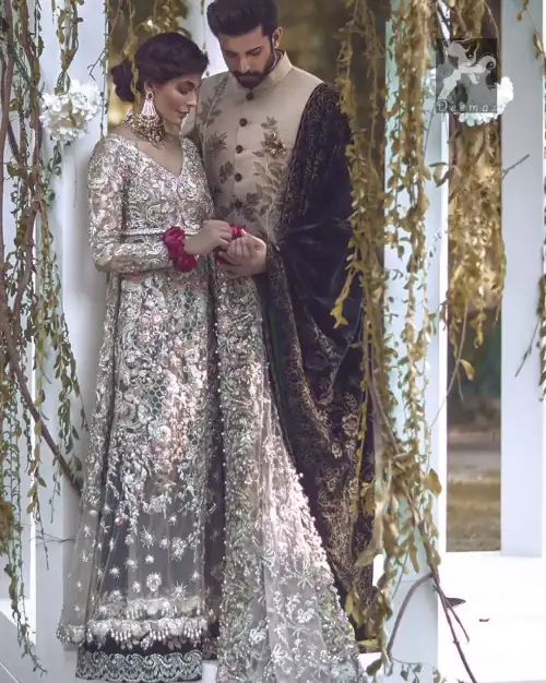 Light grayish fawn net maxi and dupatta. Bridal maxi adorned with silver, light golden, antique shades and colorful thread embellishment.