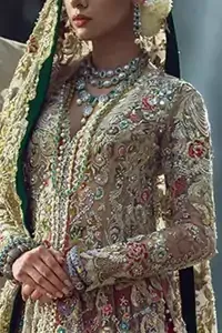 Light fawn pure crinkle chiffon front slits gown adorned with beautiful colorful embellishment. Red lehengha adorned with embellishment all over it. Light pistachio dupatta having embellished border on sides and motif spray all over it and finished with piping.