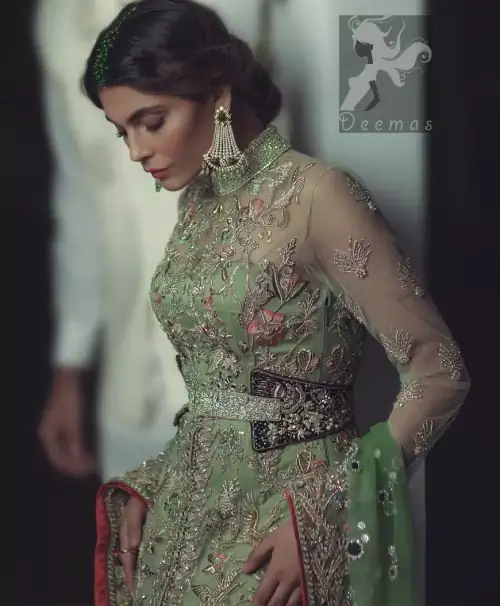 Pistachio green gown having high neck gown. Embellished Bodice with waist belt and front open slits. Mehndi green trousers having