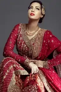 Pinkish red Angrakha style bridal maxi adorned with dull golden, antique shades of embellishment. Pure banarsi jamawar chiffon fabric has been used for long-length Angrakha. Brocade lehenga and pure banarsi chiffon jamawar dupatta.