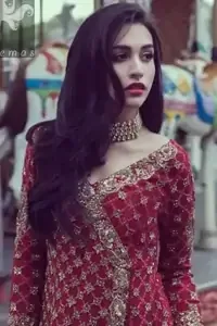 Cardinal pink self-embroidered chiffon angrakha style gown. Gown adorned with dull golden and antique shades of embellishment. Pure banarsi chiffon jamawar dupatta has an embellished border and small motifs spray. Pure banarsi chiffon jamawar gharara in Cardinal Pink and Mehndi Green.