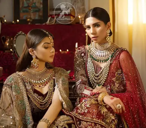 This maroon angrakha frock heavily embellished in the front with silver gold kora dabka, kundan and stones work. One side