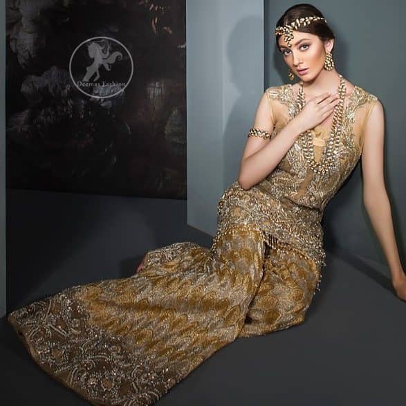 This dress is beautifully sculptured with floral embroidery. It is meticulously highlighted with antique shaded kora, dabka, tilla, sequins and pearls. It is allured with beautiful tassels which adds to the look. It is beautifully paired up with embroidered brocade sharara. It comes with organza/tissue dupatta which has four sided embellished border and applique.