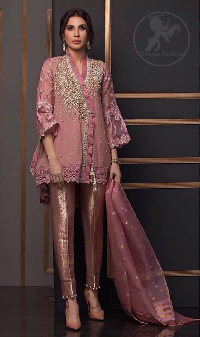 This outstanding angrakha style shirt meticulously highlighted with dull golden and antique shaded kora, dabka , tilla, sequins and pearls. This dress is beautifully adorned with floral embroidery. Sleeves are decorated with resham embroidery which adds to the look. It comes with brocade pajama. It is beautifully coordinated with chiffon dupatta having sprinkled sequins all over it.