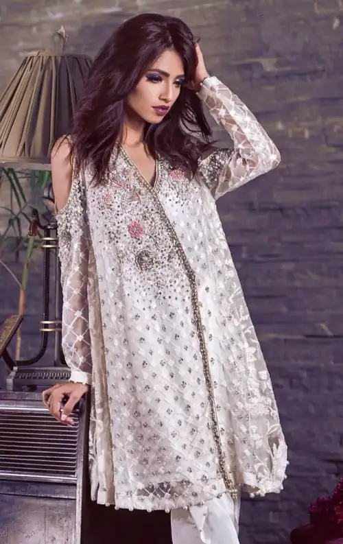 This beautiful angrakha style shirt adorned with embroidered featuring silver and antique shaded kora dabka, tilla, sequins and swarowski. Hemline