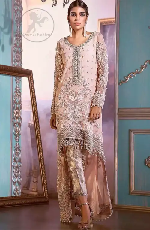 This outfit is decorated with silver kora, dabka, tilla, sequins and pearls. This dress is embellished with floral embroidery and