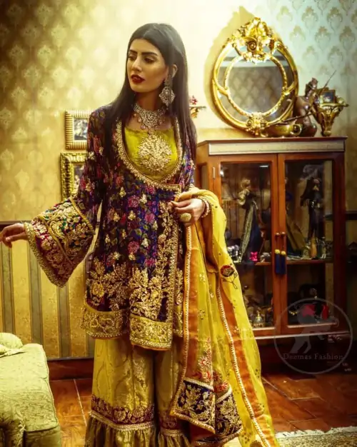 This royal blue angrakha shirt is embellished with resham thread. It is meticulously highlighted with dull golden kora dabka, tilla,