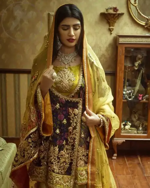 This royal blue angrakha shirt is embellished with resham thread. It is meticulously highlighted with dull golden kora dabka, tilla,