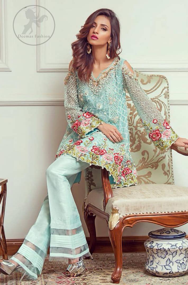 This outstanding self embroidered short frock embellished with floral thread embroidery. It is allured with resham kora dabka tilla and pearls. Sleeves are decorated with cold shoulders design and floral embroidery. Scalloped hemline ornamented with tassels. It is beautifully paired up with matching bell bottom trouser. It comes with light blue dupatta sprinkled with sequins all over it.