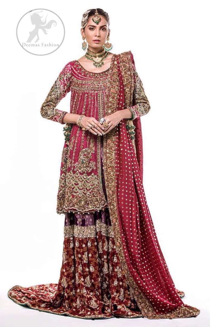 This bridal dress is adorned with floral embroidery.It is meticulously highlighted with dull golden and antique shaded kora, dabka, tilla, sequins and pearls. It has beautiful embellished bodice and U-shaped neckline which adds to the look.Sleeves are embellished with embroidered applique. Hemline is adorned with beautiful tassels. It is artistically coordinated with brocade embellished gharara. Gharara is allured with beautiful contrast of rust and plum color. It comes with pink dupatta which is decorated with embroidered borders and sprinkled sequins all over.