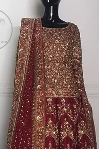 This dress is beautifully sculptured with floral embroidery. The shirt is fully embellished. It is artistically coordinated with an embellished lehenga. The lehenga is enhanced with an embroidered border and applique.