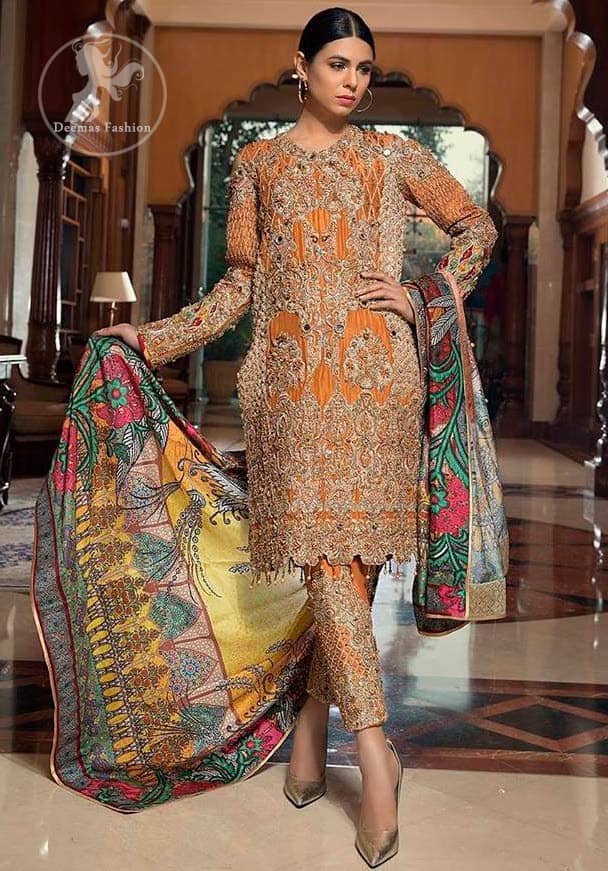 A jaffa color shirt heavily embellished in the front with antique shaded kora dabka, kundan, tilla, sequins and pearls. Floral motifs on the shirt and cold shoulder sleeves enhance the beauty of this shirt. It is finished with scalloped embellishment border. This dress is coordinated with embroidered cigarette pants and self-printed dupatta.