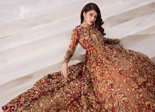 The grand maroon bridal stands out due to its uniqueness and the perfect fusion of modern cut and traditional embroidery.