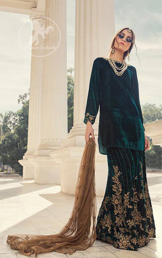 Take a step towards refreshing your wardrobe with bottle green velvet Shirt. The shirt is perfected with delicate gold tilla work. Add this bottle green velvet golden embellished bell bottom for a complete look. It comes with golden net dupatta enhanced with small motifs on the ground.