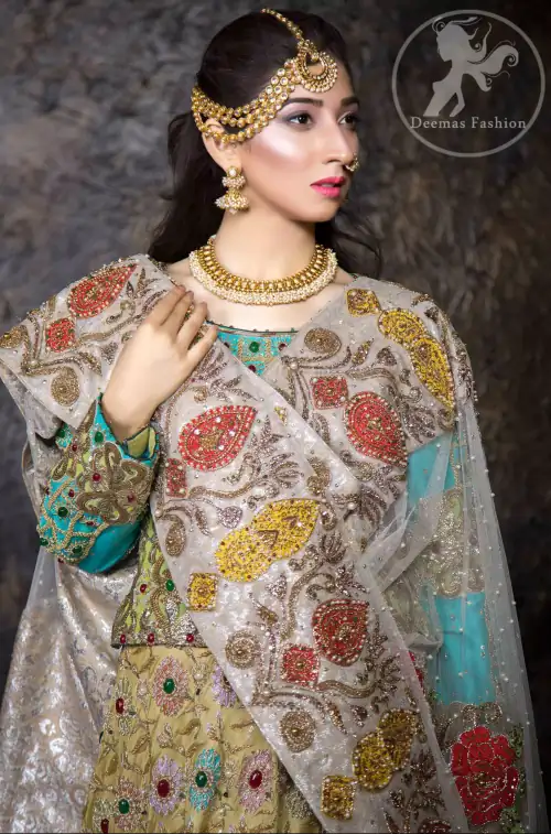 This outfit is adorned with kora, dabka, tilla, sequins and pearls. It is decorated with heavy floral embellishments. It comes