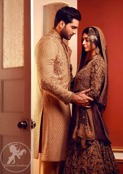 This outfit is adorned with kora, dabka, tilla, sequins and pearls. It is decorated with heavy antique shaded floral embellishments.