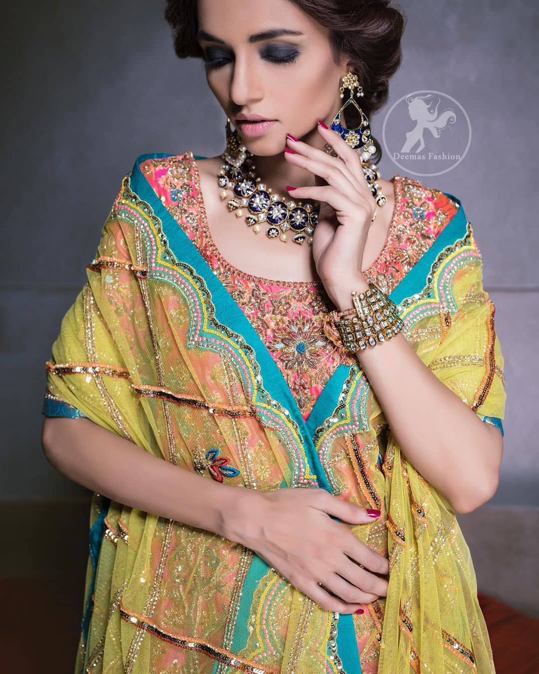 Our tea rose shirt with exquisite embellished neckline and back neckline in kora, dabka sequins and intricate thread work. The daaman is emphasized on intricate floral details that gives perfect ending to this shirt. It is coordinated with farshy gharara decorated with embroidery. The gradient turmeric dupatta has crisscross pattern and floral motifs scattered. It is finished with jamawar piping all around the edges.