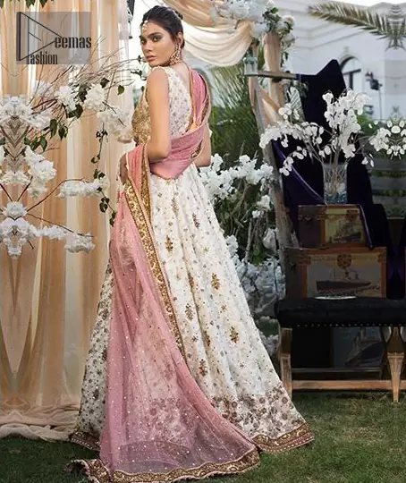 This dress is majestic beauty and perfect for your engagement or evening ensemble. Delicately crafted and personifying chic elegance with an element of grandiose. This floor length maxi is decorated with intricate thread and kora, dabka embroidery on bodice and floral motifs details all over the front on ivory canvas. The bottom of the maxi is enhanced with embellished applique. It comprises with churidar pajama. It comes with net dupatta with embellished border at all ends. Style it up with embroidered waist belt.