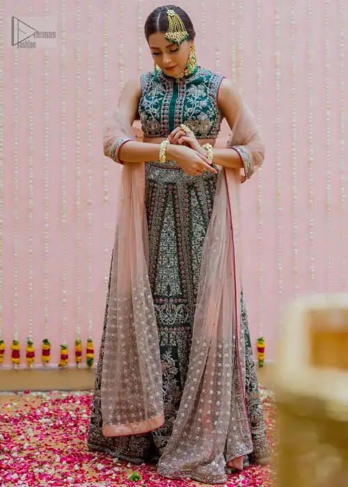 Bottle Green Velvet Blouse Lehenga Tan Dupatta. Delicately crafted and personifying chic elegance with an element of grandiose.