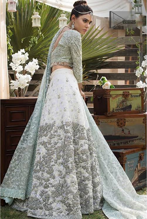 This bridal dress is perfect for your wedding or nikah day. Create a vision of elegance with this ivory self printed lehenga decorated with intricate zardosi detailing and silver kora, dabka and sequins. Furthermore it is adorned with scattered tiny floral motifs. Having quarter sleeves adorned with motifs. Beautifully coordinated with heavy embellished blouse with silver kora, dabka, sequins and pearls all over and finishing with tassels at the end. It comprises with light green self printed dupatta having matha patti border on the front and intricate beautiful border on all rest of the three sides.