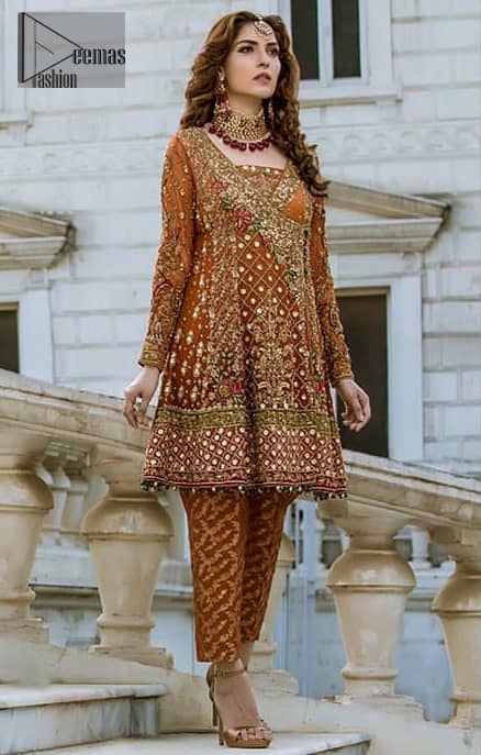 Bring out your beauty with this traditional yet modern outfit for mehndi mayon day. Make your wardrobe more interesting with this shabby chic statement intensified with rich thread embroidery and zardosi work all over the front and geometric patterns at daman that instantly draws attention. It is highlighted with antique shaded kora, dabka, sequins and pearls. Having full length sleeves adorned with floral booties. It comprises with cigarette pants. It is coordinated with beautiful dupatta with thick embellished border on two sides and scattered sequin on the ground to convey a classic look.