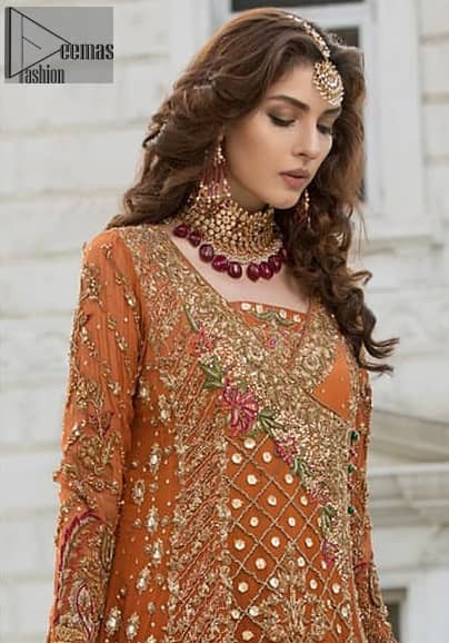 Bring out your beauty with this traditional yet modern outfit for mehndi mayon day. Make your wardrobe more interesting with this shabby chic statement intensified with rich thread embroidery and zardosi work all over the front and geometric patterns at daman that instantly draws attention. It is highlighted with antique shaded kora, dabka, sequins and pearls. Having full length sleeves adorned with floral booties. It comprises with cigarette pants. It is coordinated with beautiful dupatta with thick embellished border on two sides and scattered sequin on the ground to convey a classic look.