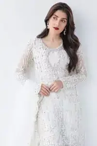 This is an ensemble that deserves to be flaunted. The ivory white shirt is an example of remarkable handiwork. With a lot of attention to detail, the intricate sequencing using glass beading and threads makes the shirt look like nothing but a dream. Furthermore the shirt is enhanced with thick embellished scalloped hemline. Sharara is magnificently decorated with scattered crystals all over. Beautifully paired it up with ivory white dupatta having four sided scalloped border.