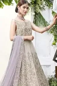The ultimate in feminine elegance with fine detail to die for. Our bride makes a statement in this stunningly floraison, perfect blend of glamour and tradition with outstanding craftsmanship and gorgeous detailing. This front open pishwas is gorgeously decorated with floral bunches all over done with antique shaded zardozi work. It comprises with light beige jamawar lehenga with zardozi detail on the bottom. Style it up with light purple net dupatta sprinkled with sequins and four sided embellished border.