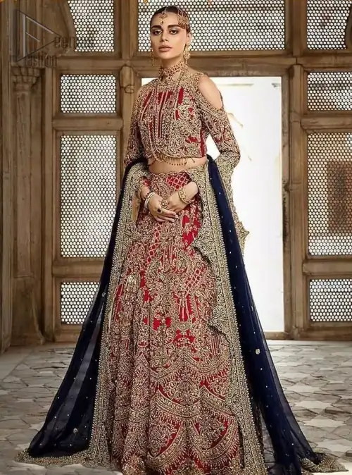 A breathtaking red traditional lehenga  paired with a detailed blouse, equally alluring make for an ensemble which is comfortably chic.