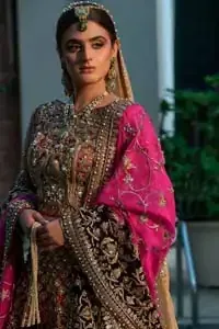 Complete your big day with the perfect dress in our selection of stunning wedding dresses. This regal lehenga blouse is an immensely captivating traditional piece, enhancing the art of classical heritage showcasing the craftsmanship of kora, dabka, tilla and sequibs detailed with pearls, artistically embellished to give a beautiful rhythm to the outfit. The lehenga is adorned with golden and antique shaded embroidery. Furthermore the bottom of the lehenga is enhanced with black embellished applique. Coordinated with beige dupatta sprinkled with sequins all over.