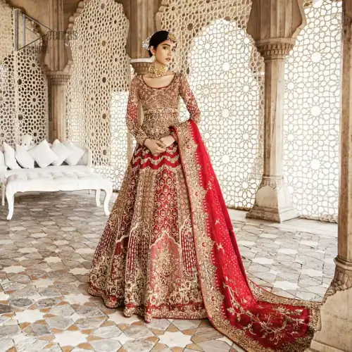 Captured in traditional silhouette, This traditional red pishwas is aesthetically designed with motifs,geometric and floral patterns, embellished with kora, dabka,