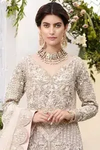 Make a special day even more magic with our exquisite flora bridal maxi dress. Discover classic look in this outfit for a traditional style, with delicate detailing and intricate accents for a subtle yet sophisticated look, having full sleeves with zardozi details. Furthermore the hemline is emphasized with a large central motif and small motifs around it that gives perfect ending to the outfit. It comes with tea pink lehenga with zardozi details on the bottom. Paired with light purple net dupatta sprinkled with sequins and four sided embellished border that gives the right amount of glamour to the outfit.