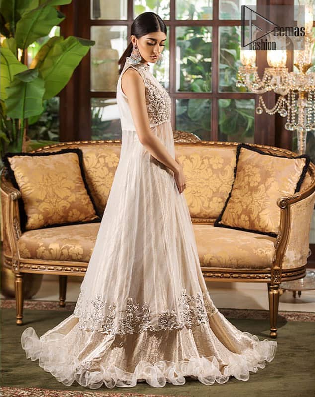 This halter neck frock is majestic beauty. Delicately crafted and personifying chic elegance with an element of grandiose. A full heavily embroidered bodice done with silver and gray zardozi work. The bottom of the frock is enhanced with rich floral embroidery and wide hemline. It comprises with brocade lehenga and net frilled lift the whole lehenga bottom. Complete the look with tea rose dupatta sprinkled with sequins on all over the ground.