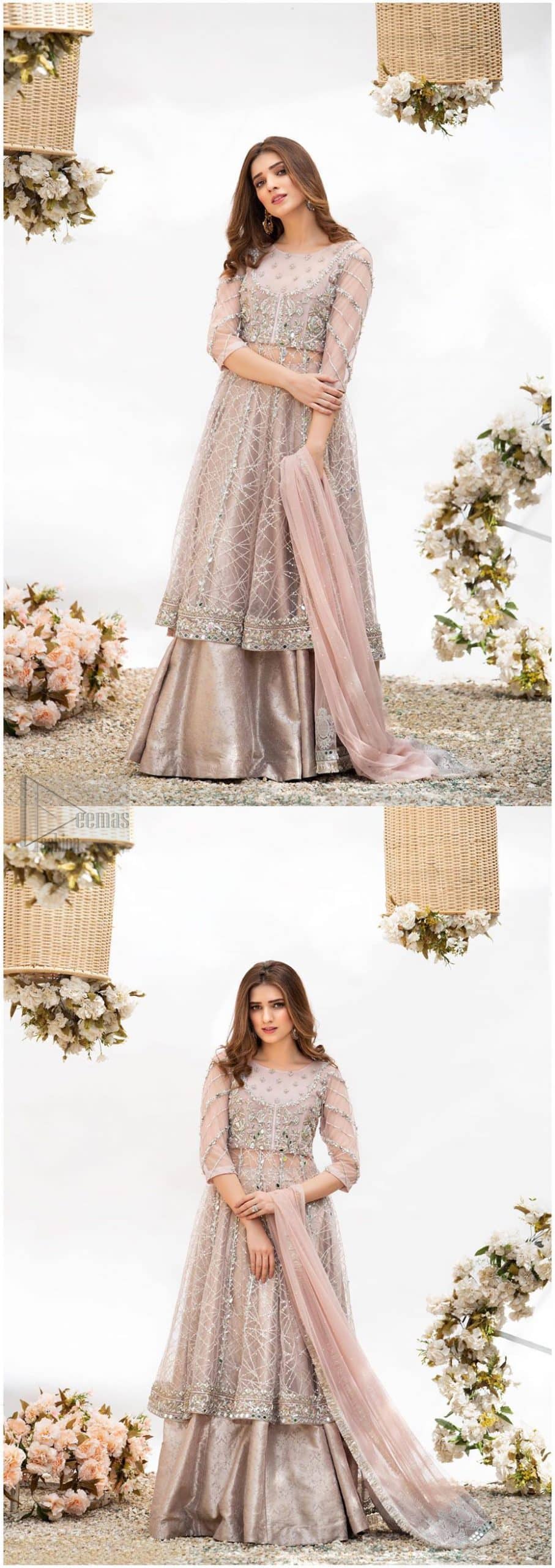 Embrace the season of festivities with this beautiful dress. Dazzle in this made to perfection, richly embroidered net outfit decorated with intricate embroidered front highlighted with silver and light golden zardozi work borders on daaman and embroidered stripes on sleeves. The bodice is fully furnished with zardozi work and sprinkled with floral motifs around neckline. The outfit is comprises with brocade sharara and tea pink net dupatta adorned with sequins spray all over.