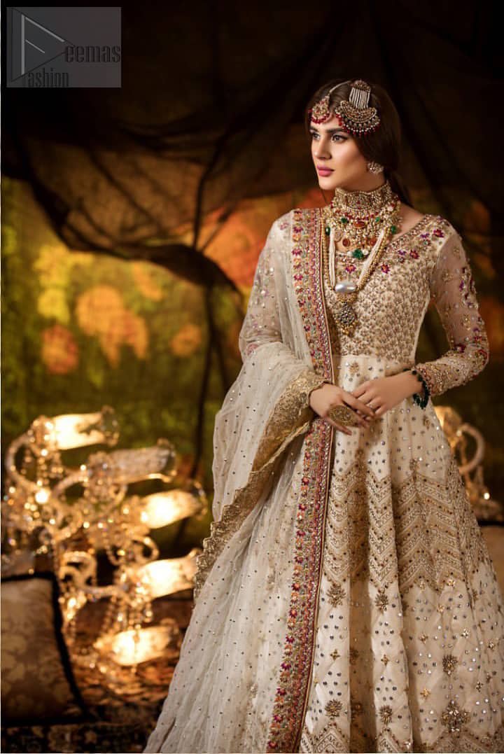 Delicately crafted and personifying chic elegance with an element of grandiose. This outfit is beautifully sculptured with geometric embroidery, adorned with heavy embellished bottom with golden and antique shaded kora, dabka, pearl and sequins work all over. Furthermore the outfit is emphasized with colorful thread work and mukesh embroidery. It is coordinated with ivory dupatta with sequins sprayed all over it along with zardozi work all around the edges to make the look complete.
