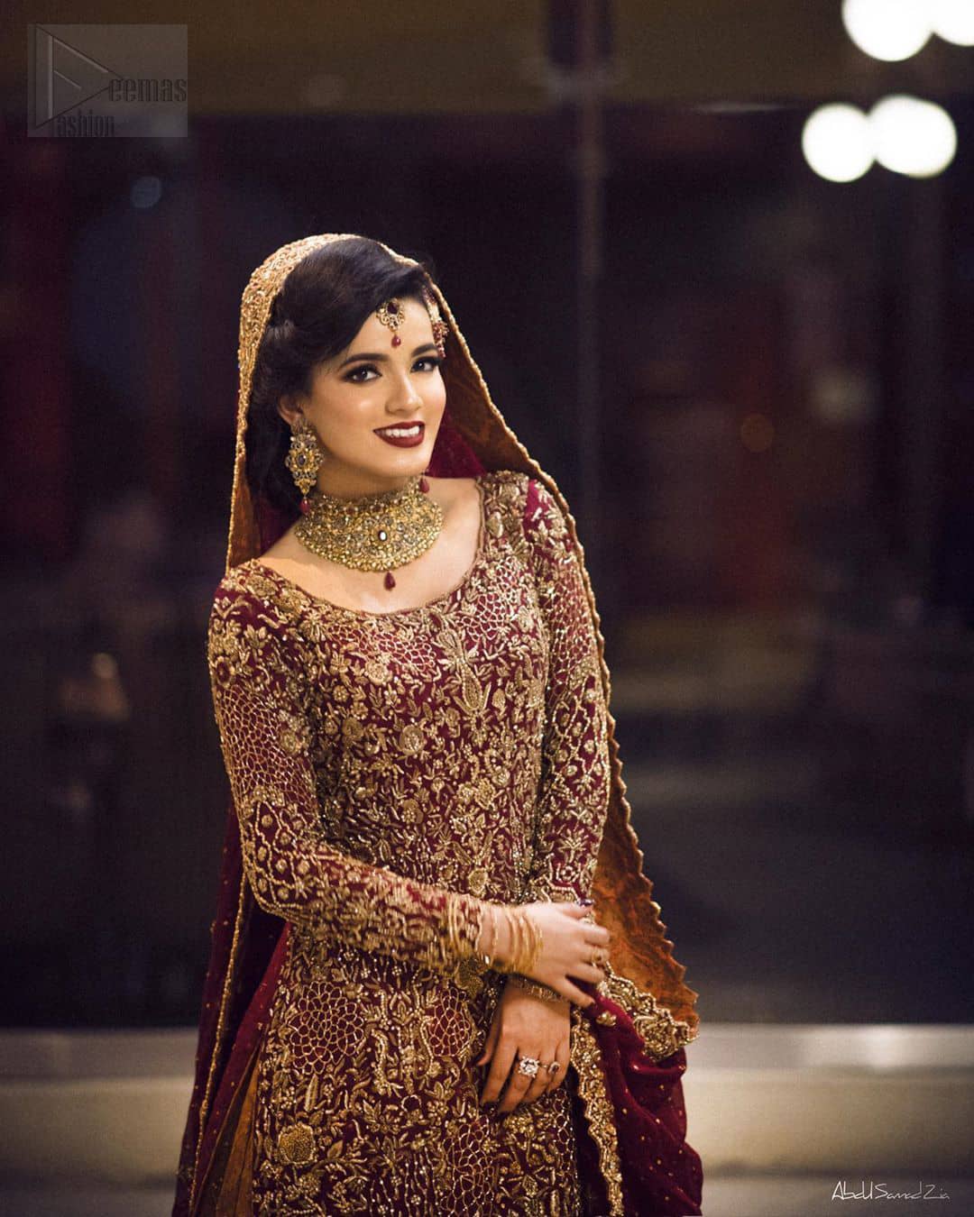 You are all set to make a lasting impact with the divine royalty of this dress. This ravishing ensemble is sure to make you look like glamorous royalty with immaculate work covering every inch of the shirt. It boasts a pretty scallop hemline and full sleeves with zardozi embellishment. Compliment the look with flared lehenga. The combination of rust with maroon is absolutely breathetaking. Elegance is personified when it gets paired up with an all-over sequins spray on dupatta dupatta with alternating scalloped borders detailing. This is an ensemble that deserves to be flaunted.