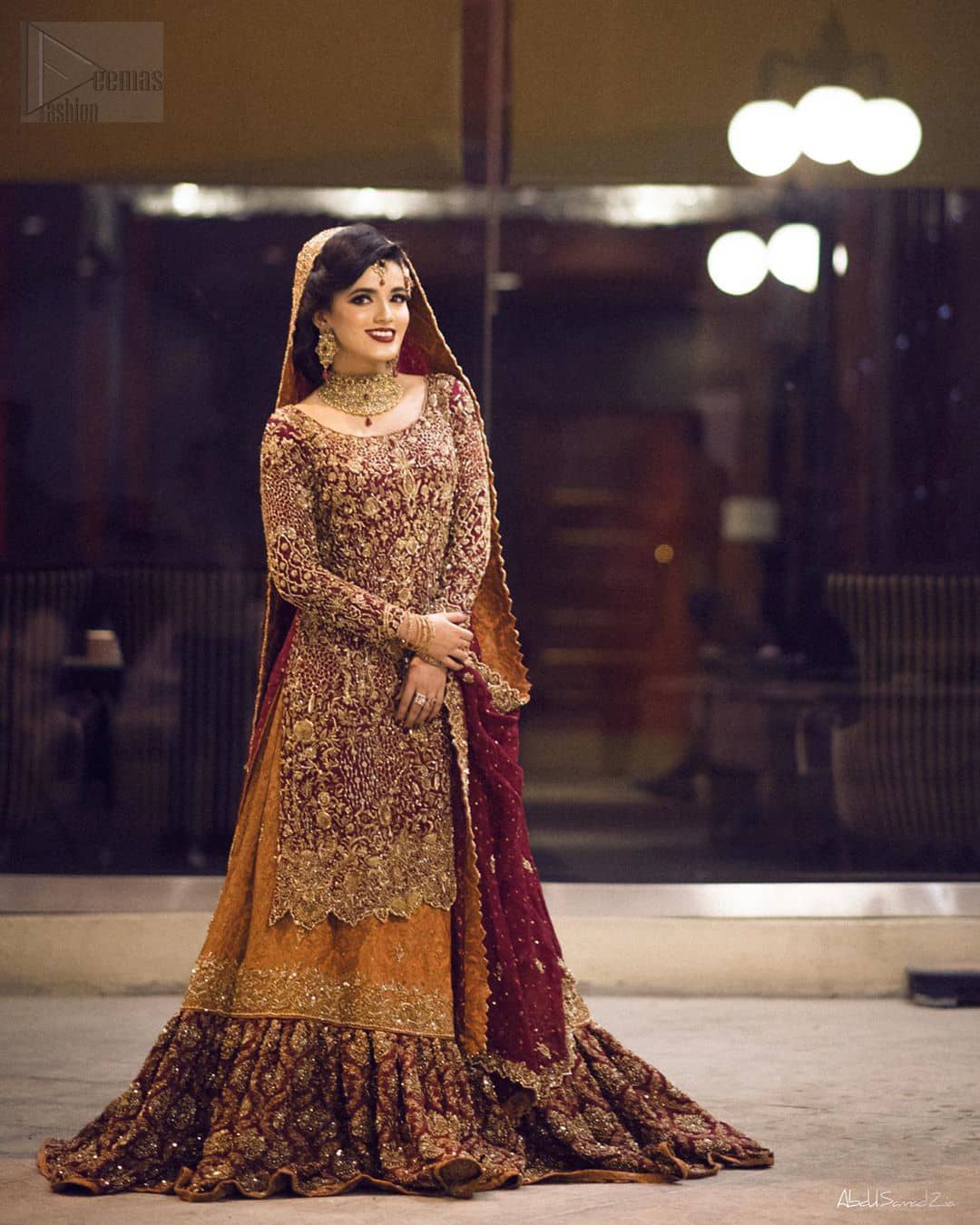 You are all set to make a lasting impact with the divine royalty of this dress. This ravishing ensemble is sure to make you look like glamorous royalty with immaculate work covering every inch of the shirt. It boasts a pretty scallop hemline and full sleeves with zardozi embellishment. Compliment the look with flared lehenga. The combination of rust with maroon is absolutely breathetaking. Elegance is personified when it gets paired up with an all-over sequins spray on dupatta dupatta with alternating scalloped borders detailing. This is an ensemble that deserves to be flaunted.