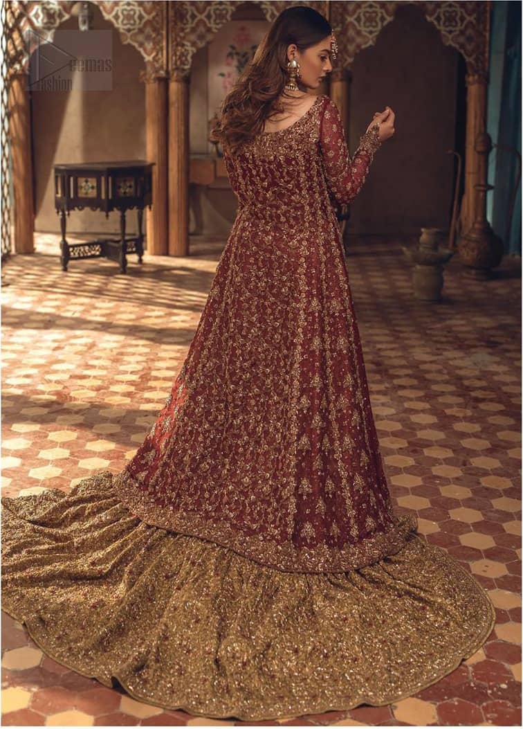 This wedding season, create a blissful aura with the treasure of love and elegance. An artistic vision of classic style and luxurious detailing, transpire into a truly romantic and iconic bridal for your big day. The front open floor length maxi is adorned with unique geometric patterns around the neckline and rest of the maxi is ornamented with floral embroidery. The kora, dabka, tilla and pearls embroidery is done in the shade of tan. Compliment the look with wide flared lehenga. The combination ofgolden with maroon is absolutely breathetaking. The dupatta incorporates beautifully designed borders on all four sides and sprinkled sequins to give it a perfect maharani look.