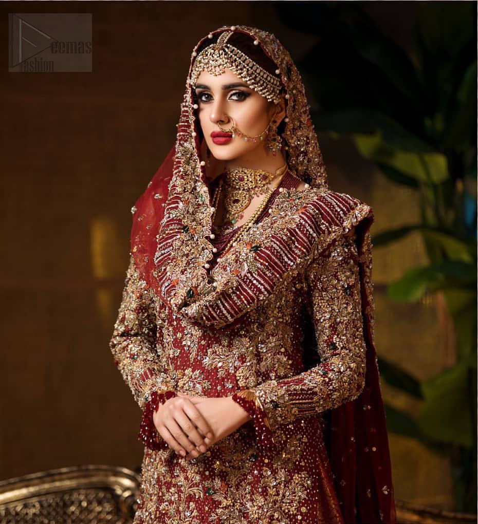 Captured in traditional silhouette. The bridal stands out due to its uniqueness and the perfect fusion of modern cut and traditional embroidery. This dress is beautifully highlighted with zardozi work in the shades of tan and silver. The hemline of the shirt is adorned with scalloped finishing and tassels on the sleeves. It comes with katan banarsi gharara with wide flare decorated with kora, dabka, tilla and pearls work. It is coordinated with organza dupatta which is sprinkled with sequins all over it. It is further furnished with four sided scalloped border.