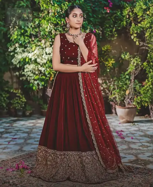 Let the crowd stare and make it worth their while when you walk wearing this maroon velvet lehenga blouse. Designed