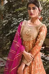 Let the crowd stare and make it worth their while when you walk wearing this anarkali frock. Designed to flaunt your best features, the bodice carries intricate zardozi work. Furthermore this multiple panel frock is enhanced with gota work and beautiful applique on bottom embellished with golden kora, dabka, tilla, sequins and beads work. Pair it up with pink churidar pajama and pink organza dupatta emphasized with gota work and four sided kiran lace. Upholding the idea of simple is beautiful, you would definitely want to wear this for your next occasion.