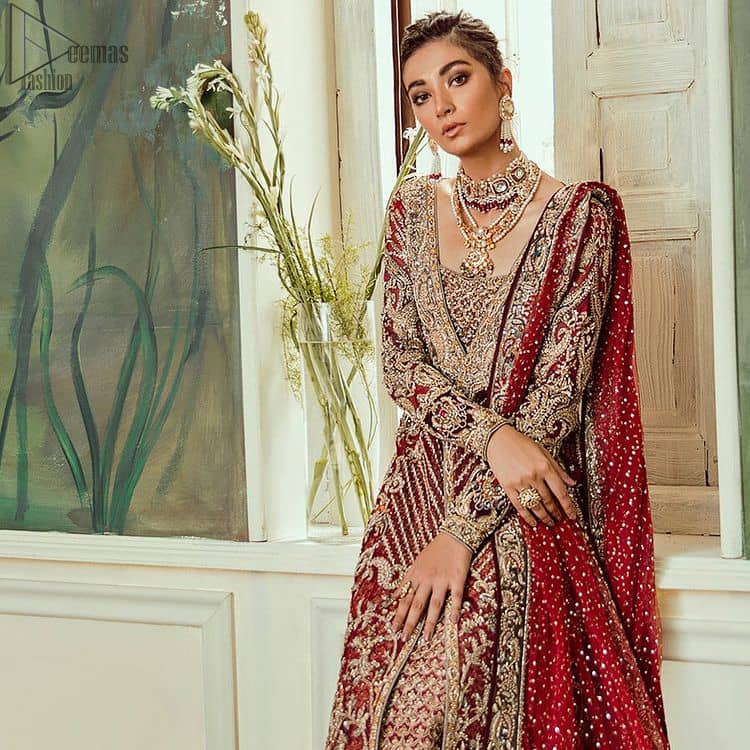 Deep red jacket gown having inner velvet blouse with maroon back train lehenga and heavily embroidered dupatta.