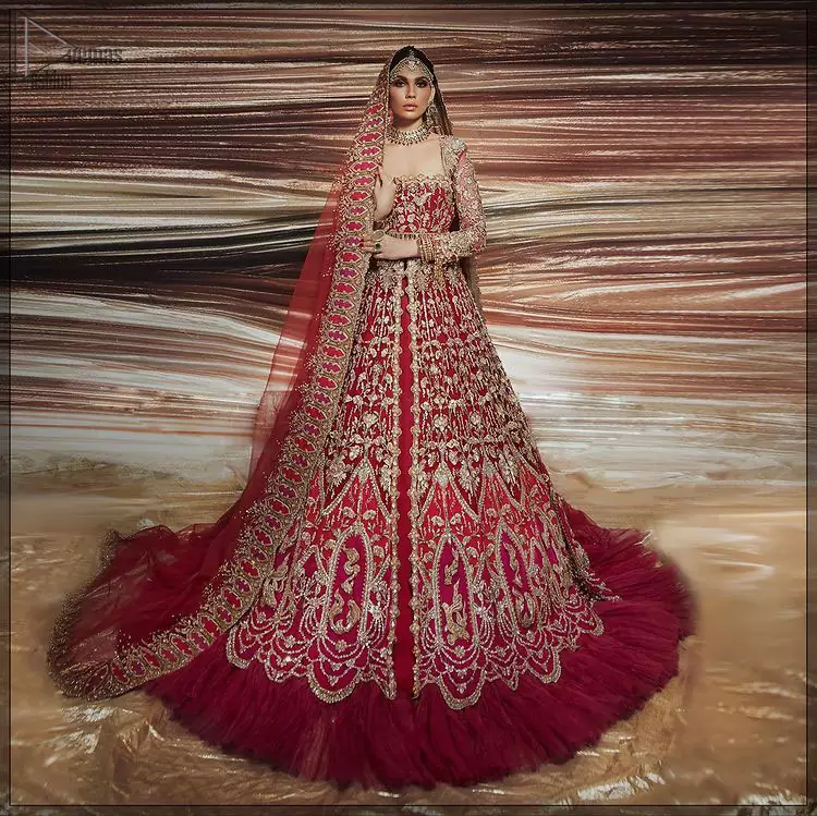 A bride wants to feel as beautiful as she is on her special day, and knowing that our Lehenga was the final decision in that, it is priceless. This bold and iconic bridal ensemble with its dainty flutter silhouette leaves us feeling whimsical, romantic, and even a bit enchanted. This front open pishwas is laden with silver and golden zardozi work, a beautifully crafted waist belt and floral embroidery patterns. The dress is even more enhanced with the ruffled bottom. It is coordinated with a beautiful dupatta with thick matha Patti borders along the length and an intricate beautiful border on the rest of the two sides.