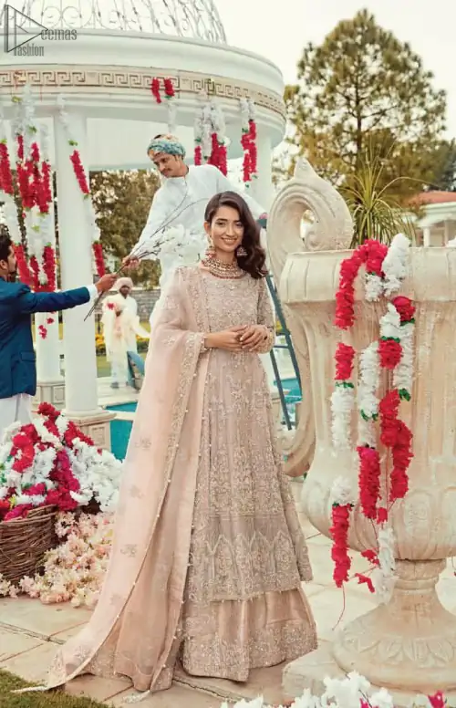 Bringing traditional charm to your big day with intricately silver and light golden embellished neckline and thick worked lines all