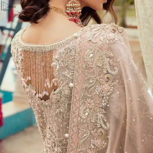Bringing traditional charm to your big day with intricately silver and light golden embellished neckline and thick worked lines all