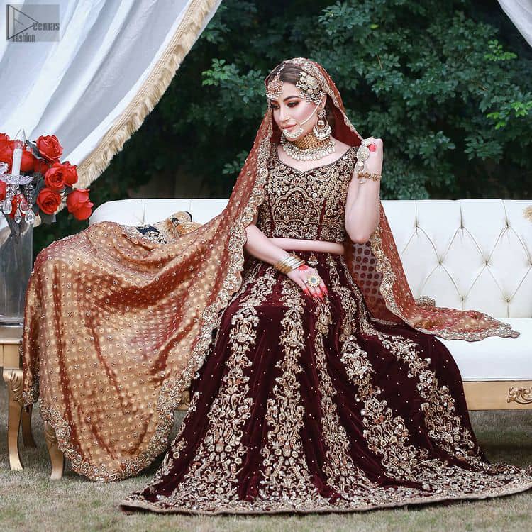 While an outstanding Maroon Velvet lehenga finalizes the overall dress, intensifying the sparkling copper embroidery over it.