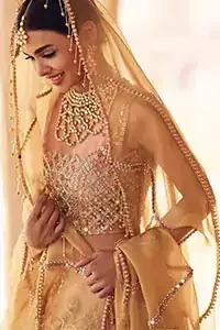 Take all the attention of the guests with your exquisite look with one of the best outfits from Deemas Fashion. Comprising of a peach organza round neckline blouse with complete zardozi work. This exceptionally embellished outfit is organized with a fawn organza dupatta which is sprayed with sequins glorifying its grace. Peach organza lehenga emphasized with floral bunches done with kora, dabka, tilla and sequins work. Making it true that you can turn all the heads around with your gorgeous ability to wear the outfit in a way that is spectacular.