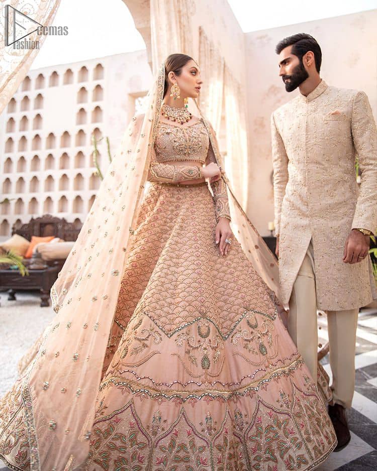 Pakistani Wedding Wear Peach Blouse Lehenga. DupattaThis breathtaking fit and flare wedding dress offers comfort without compromising on style. This nude peach colour is the perfect feminine and delicate shade with its meticulously crafted fabrication with gorgeous embroideries. The multiple colour embroidery The outfit comes with an embroidered belt. Adorned with sterling sequences and silver and crystal hand embellishments, it's a classic modern masterpiece!